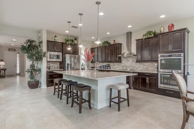 The open floor plan features large kitchen just of