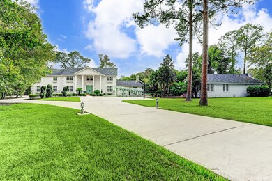A view of the property showcasing the elongated circle driveway with an additional parking area