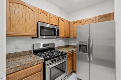 Kitchen featuring tile countertops and stainless s