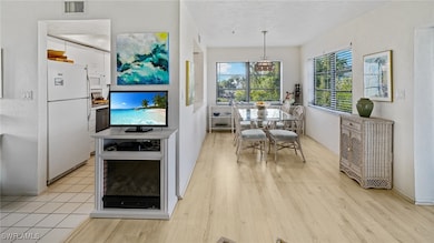 Dining area with walls of windows, electric firepl