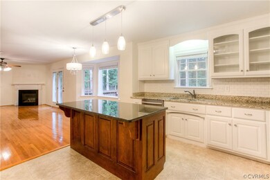 Look at the amazing cherry island with counter-height seating area. Great work and gathering area also!