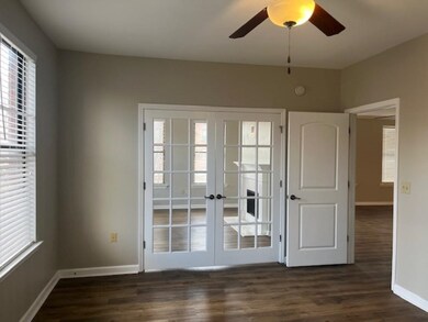 Doorway to outside featuring ceiling fan, dark har