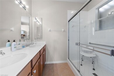 Full bathroom with double vanity, tile patterned f