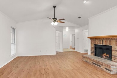 Unfurnished living room featuring a fireplace, orn