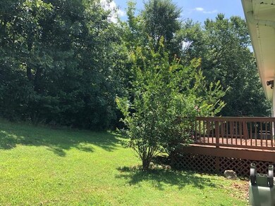 Rear deck looks out on private back yard.