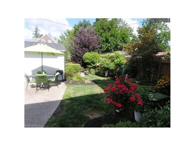Front and back yards overflowing with lush landsca