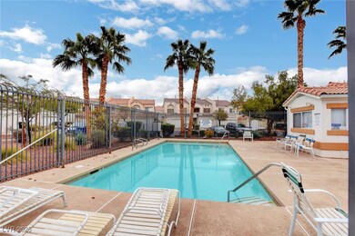 Community pool with a residential view and a patio