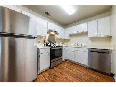 Kitchen with light countertops, appliances with s