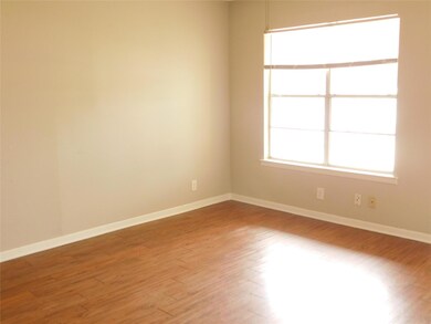 Unfurnished room with baseboards and light wood f