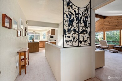 The charming entrance foyer, with an approach to the kitchen as well as the dining room. The stairs leading to the lower level are located on the other side of the half wall.