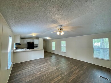 Entry to the home shows the living room and kitchen area