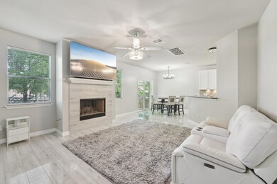 Living area with baseboards, a ceiling fan, a til