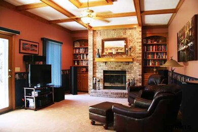 Rich hardwoods and built-ins with patio access.