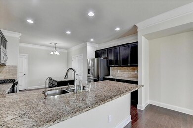 Kitchen featuring stainless steel appliances, a si