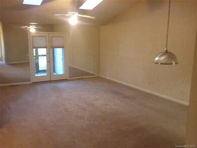 Great room with skylights and mirror wall to add v