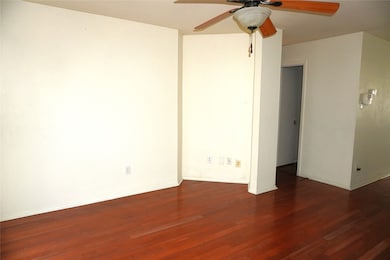 The living room is open to the kitchen and dining
