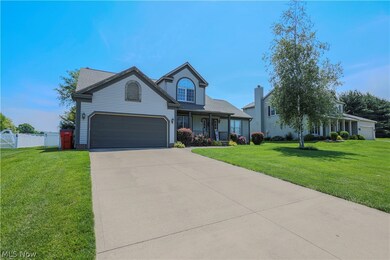 View of front of home featuring a garage and a front yard