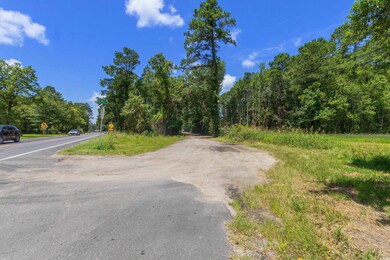 View of asphalt road with traffic signs and a wooded view