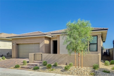 View of front of property with stucco siding, a fenced front yard, and decorative driveway