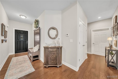 Spacious entryway with gorgeous hardwood floors.