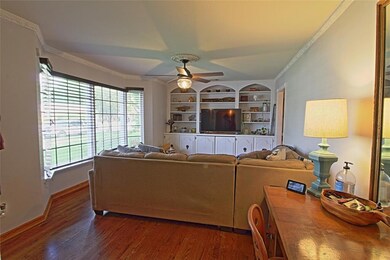 Living room with built-in cabinets and shelving.