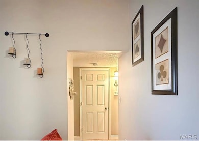 Hall with a textured ceiling