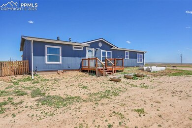 Back of house featuring fence and a deck