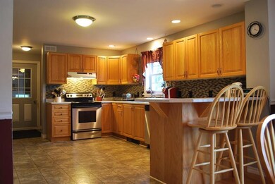 Open kitchen with oak cabinets, side...