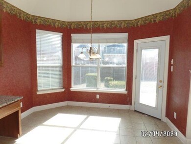 Cheery breakfast room overlooks rearyard