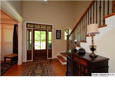 Two story foyer with formal dining room on right a