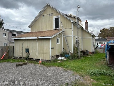 Rear view of house featuring a chimney