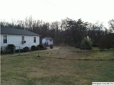 Side of house and vacant lot.