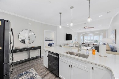 Kitchen with sink, white cabinetry, hardwood / woo