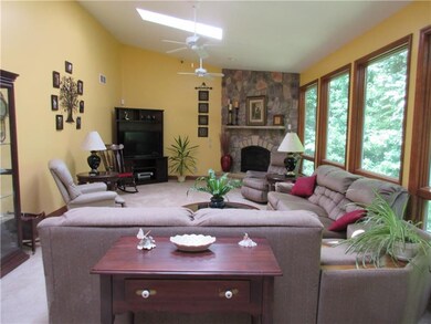 LIVING ROOM WITH STONE GAS FIREPLACE, 3 SKYLIGHTS,