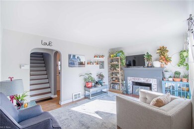 It features hardwood floors, a cozy living room wi
