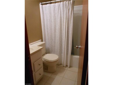 Main bath has ceramic tile flooring, newer tub sur