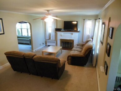 living room with wood burning fireplace.