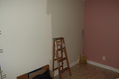 Unfurnished room with baseboards