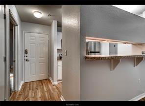 Entrance foyer with baseboards and wood finished f