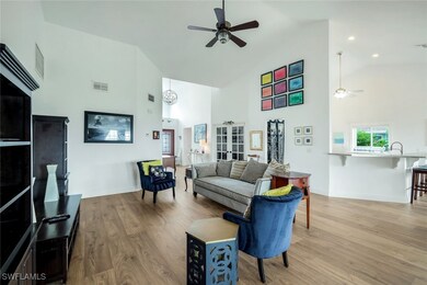 Living room featuring ceiling fan, high vaulted ce