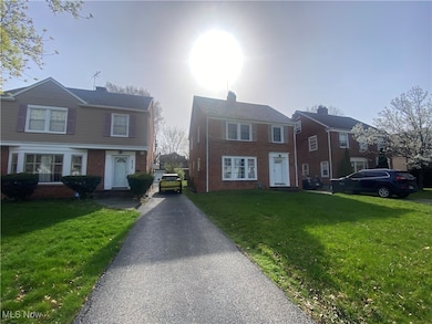 View of front facade featuring a front lawn and brick siding