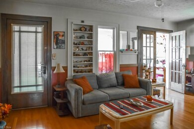 Upstairs unit living room with built-ins, hardwood