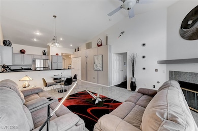 Living room with a ceiling fan, recessed lighting,