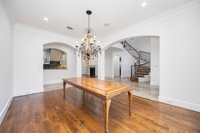 This elegant dining area features hardwood floors,