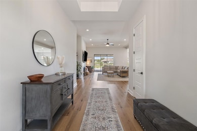 Hall featuring wood finished floors and recessed 