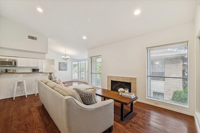 This lovely unit has an open floor plan, gleaming hardwoods, high ceiling, recessed lighting, a wood burning fireplace and a fresh coat of Sherwin Williams interior paint.