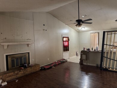 Living room with lofted ceiling, wood finished flo