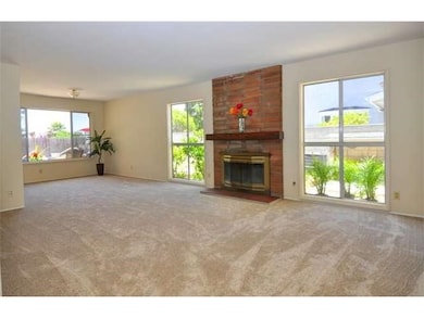 Large, open living room with woodburning gas fireplace