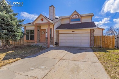 View of front of house featuring a garage, brick s