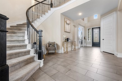 This curved staircase with wrought iron balusters